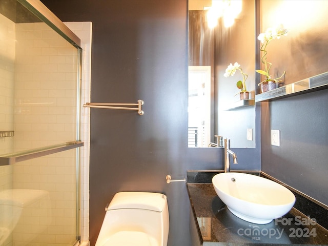 bathroom featuring vanity, an enclosed shower, and toilet