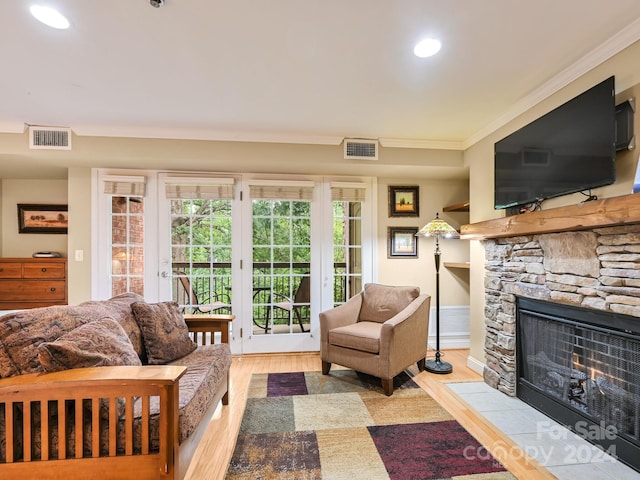 218 Bowling Park Rd Unit 218, Asheville, NC 28803 - living room with crown molding, a fireplace, french doors, and light wood-type flooring