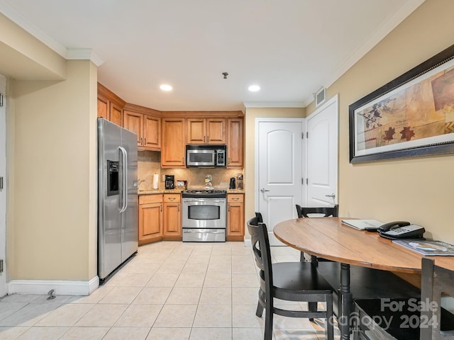 218 Bowling Park Rd Unit 218, Asheville, NC 28803 - kitchen featuring decorative backsplash, appliances with stainless steel finishes, light stone counters, crown molding, and light tile patterned floors