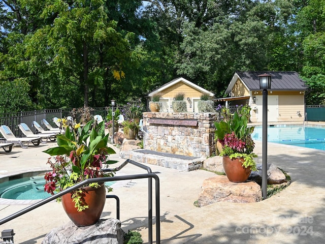 218 Bowling Park Rd Unit 218, Asheville, NC 28803 - view of patio featuring a community pool and an outdoor structure