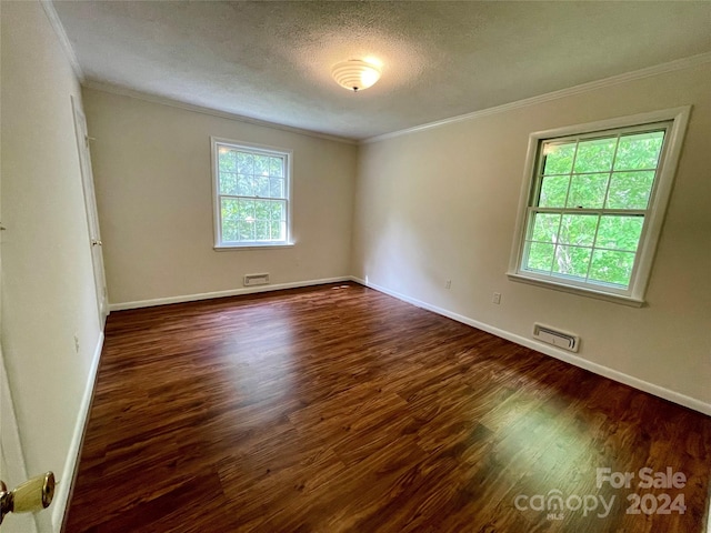 unfurnished room featuring dark hardwood / wood-style flooring, crown molding, and a textured ceiling