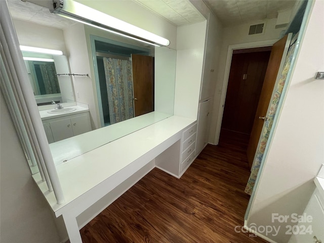 bathroom featuring hardwood / wood-style flooring and vanity