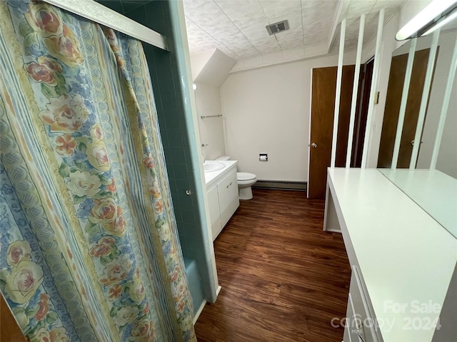 bathroom featuring vanity, walk in shower, toilet, hardwood / wood-style flooring, and a baseboard heating unit