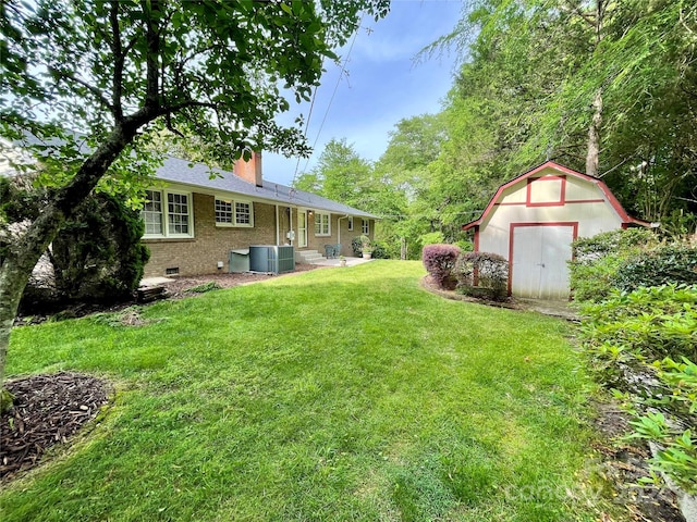 view of yard with central air condition unit, a shed, and a patio