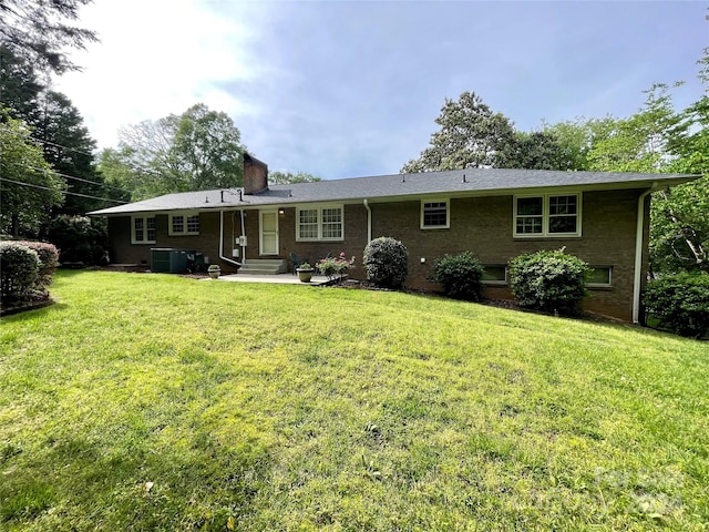 ranch-style home with central AC, a front yard, and a patio