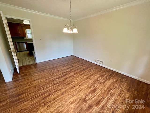 unfurnished dining area featuring hardwood / wood-style flooring, crown molding, and a notable chandelier