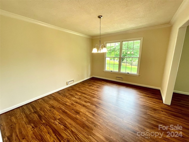 empty room with ornamental molding, dark hardwood / wood-style flooring, a notable chandelier, and a textured ceiling