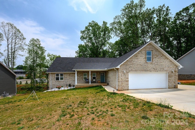 view of front of property featuring a garage, a front yard, and a porch