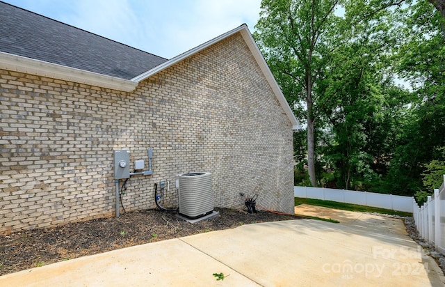 view of property exterior featuring a patio area and central AC