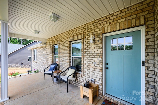 view of exterior entry with a porch