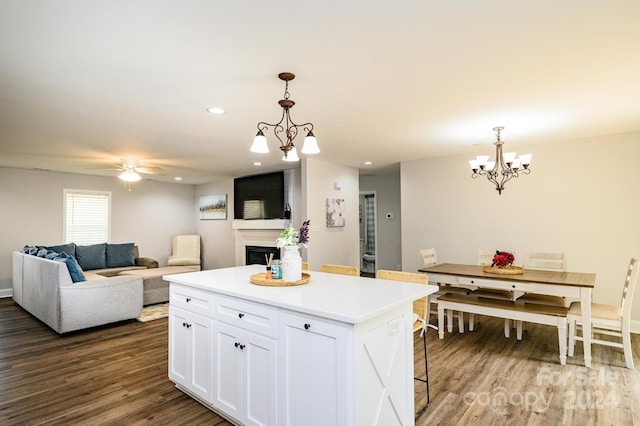 kitchen with white cabinetry, a center island, dark hardwood / wood-style flooring, and hanging light fixtures