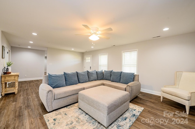 living room featuring ceiling fan and hardwood / wood-style floors