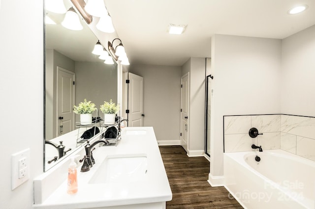 bathroom with hardwood / wood-style floors, vanity, and separate shower and tub