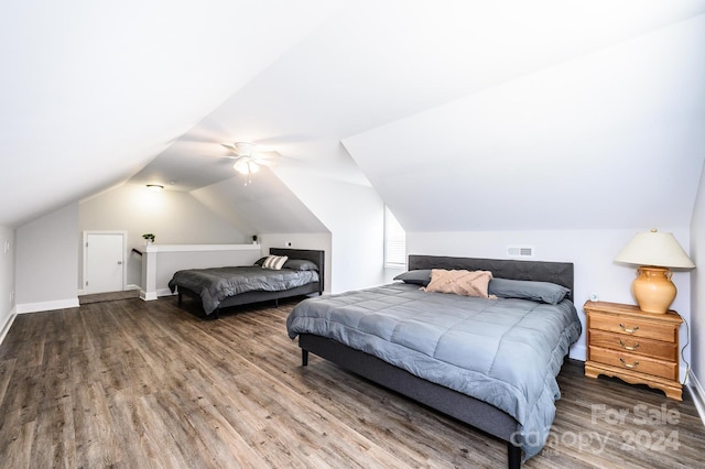 bedroom with ceiling fan, hardwood / wood-style flooring, and vaulted ceiling