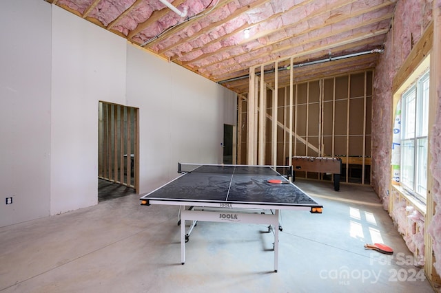 recreation room with concrete flooring