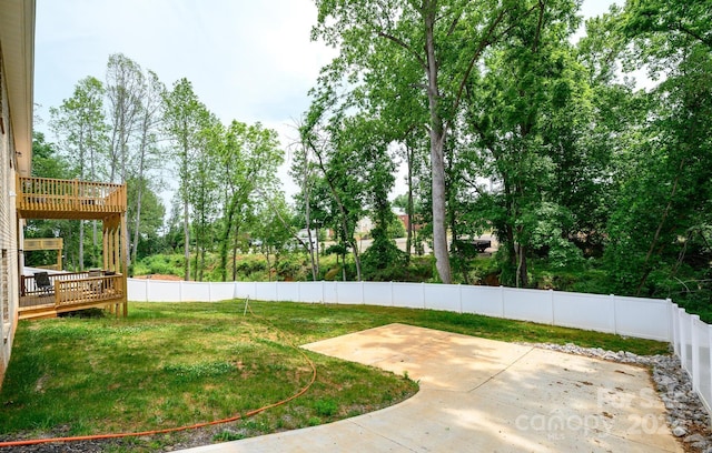 view of yard with a deck and a patio