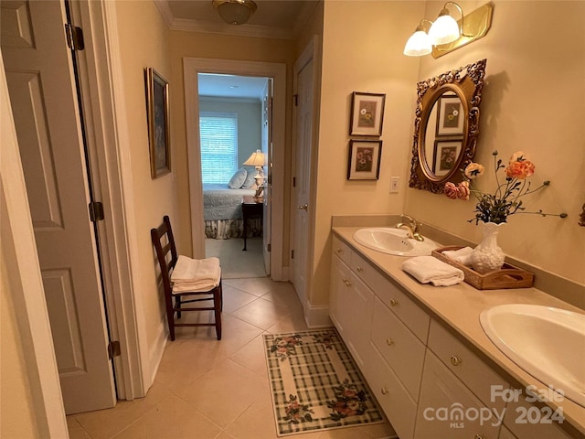 bathroom with tile flooring, vanity with extensive cabinet space, double sink, and ornamental molding