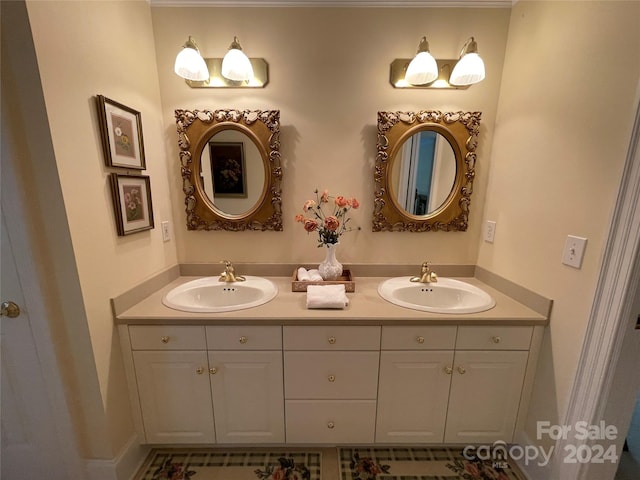 bathroom featuring vanity with extensive cabinet space and dual sinks