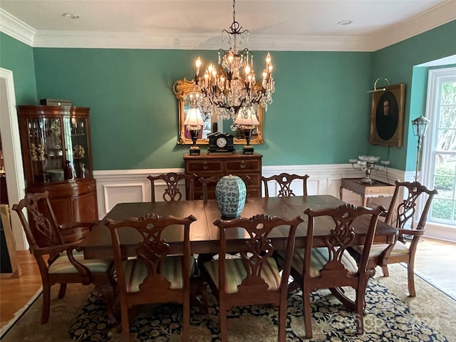 dining area with a chandelier, plenty of natural light, hardwood / wood-style flooring, and ornamental molding