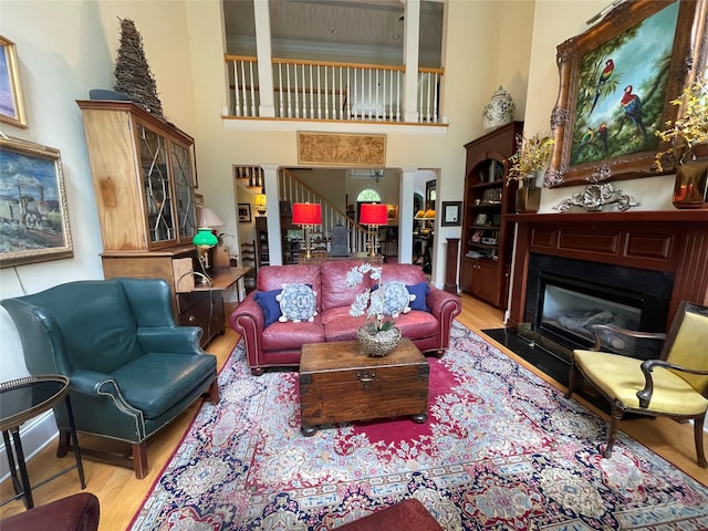 living room featuring light hardwood / wood-style floors and a towering ceiling