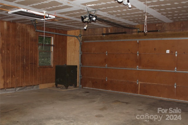 garage featuring wood walls