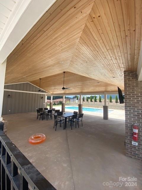 view of patio featuring ceiling fan and a community pool