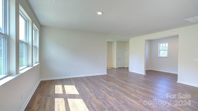 unfurnished room with dark hardwood / wood-style floors