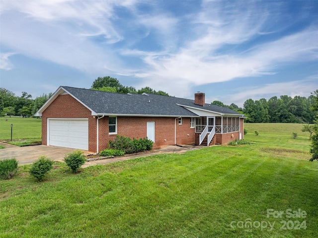 ranch-style house with a garage, a front yard, and a sunroom