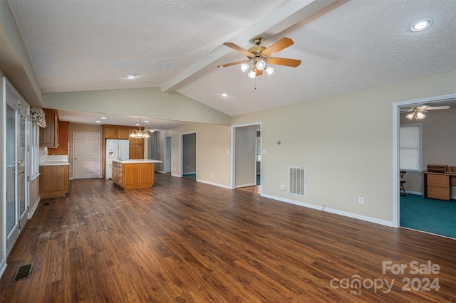 unfurnished living room featuring ceiling fan with notable chandelier, a textured ceiling, dark wood-type flooring, and vaulted ceiling with beams