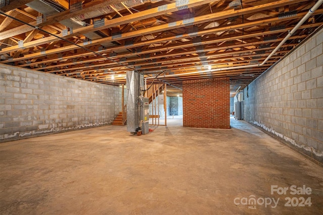 basement featuring brick wall