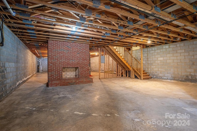 basement featuring a brick fireplace