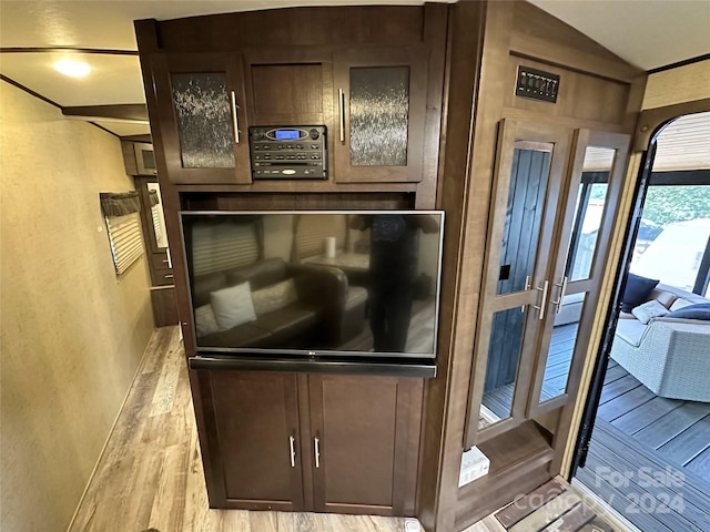 details featuring light hardwood / wood-style flooring and oven