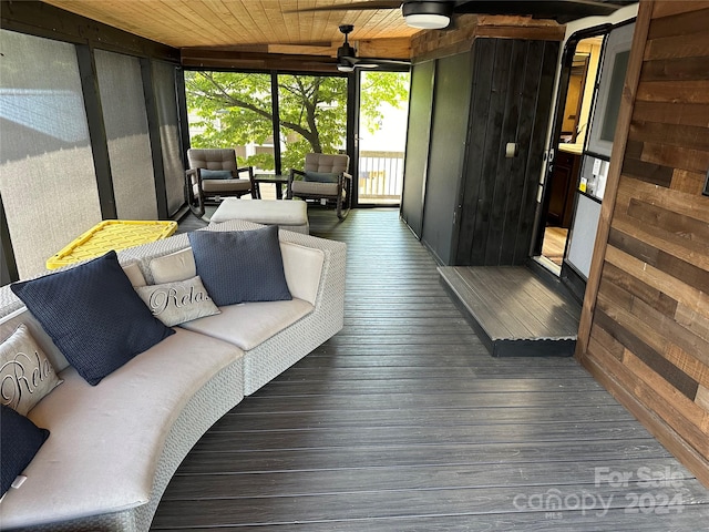 sunroom with ceiling fan and wooden ceiling