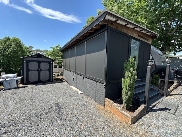 view of side of home with a shed