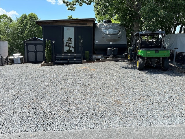 view of front of house featuring a storage shed