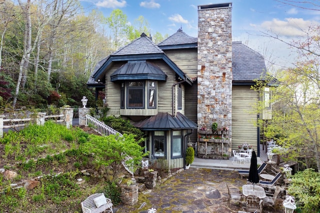 back of property with a gazebo and a patio area