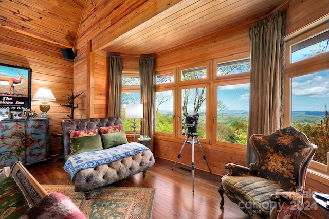 living area featuring wood ceiling, plenty of natural light, wood-type flooring, and wooden walls