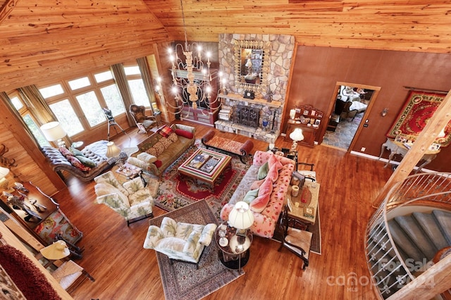 living room with high vaulted ceiling, an inviting chandelier, hardwood / wood-style flooring, and wood ceiling