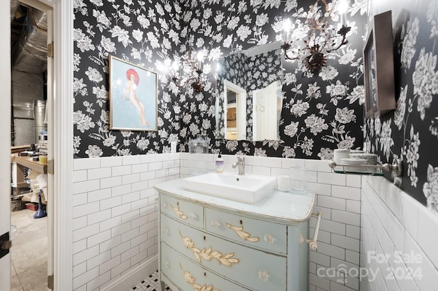 bathroom featuring tile walls, tasteful backsplash, vanity, and tile floors