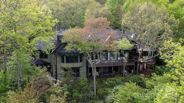 rear view of house featuring a balcony and central air condition unit