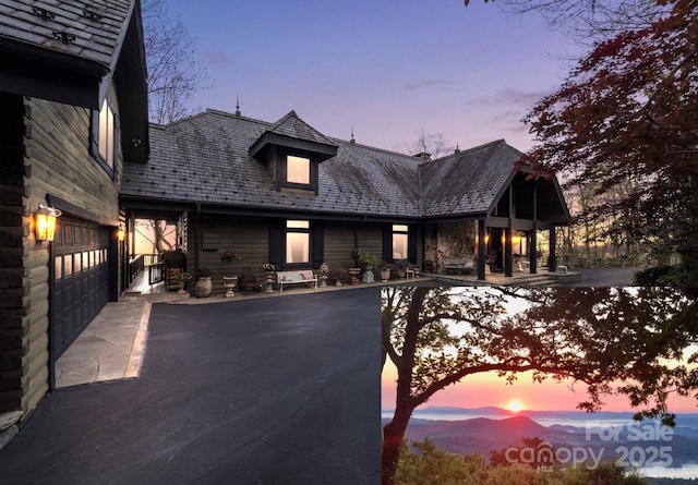1052 Toxaway Dr, Lake Toxaway, NC 28747 - view of front of house featuring a high end roof and asphalt driveway