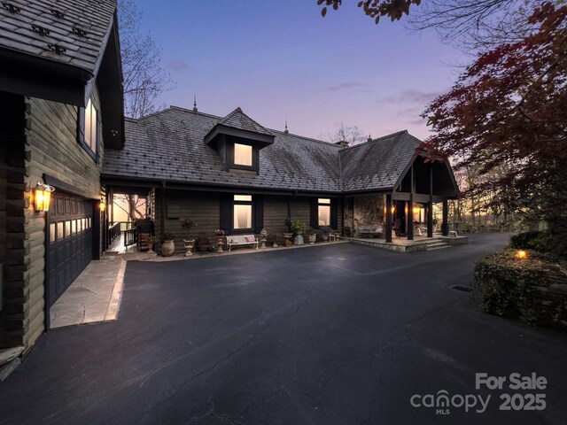 1052 Toxaway Dr, Lake Toxaway, NC 28747 - view of front of house featuring a high end roof and driveway