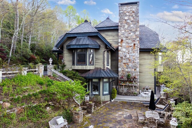 1052 Toxaway Dr, Lake Toxaway, NC 28747 - back of house featuring a patio and a chimney