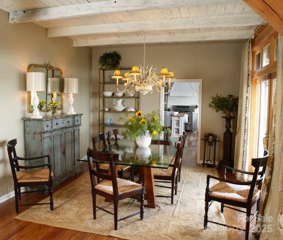 1052 Toxaway Dr, Lake Toxaway, NC 28747 - dining area with a chandelier, light wood finished floors, and wood ceiling with exposed beams