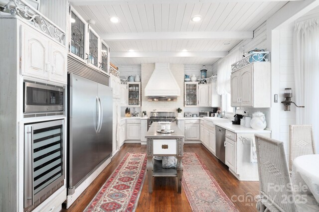 1052 Toxaway Dr, Lake Toxaway, NC 28747 - kitchen with beverage cooler, custom range hood, built in appliances, dark wood-style floors, and a kitchen island