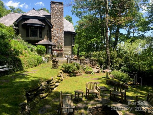 1052 Toxaway Dr, Lake Toxaway, NC 28747 - view of grassy yard featuring view of wooded area