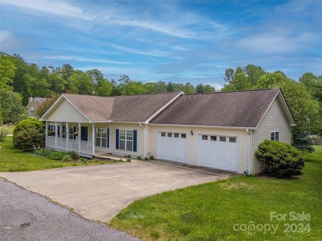 single story home with a porch, a garage, and a front yard