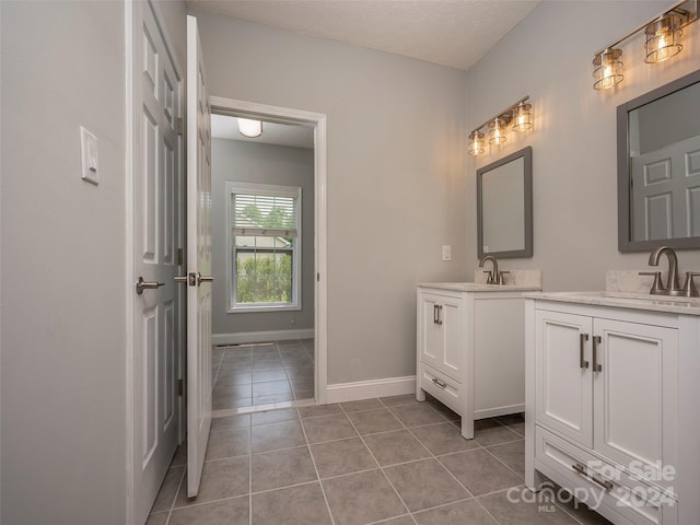 bathroom with double vanity and tile flooring