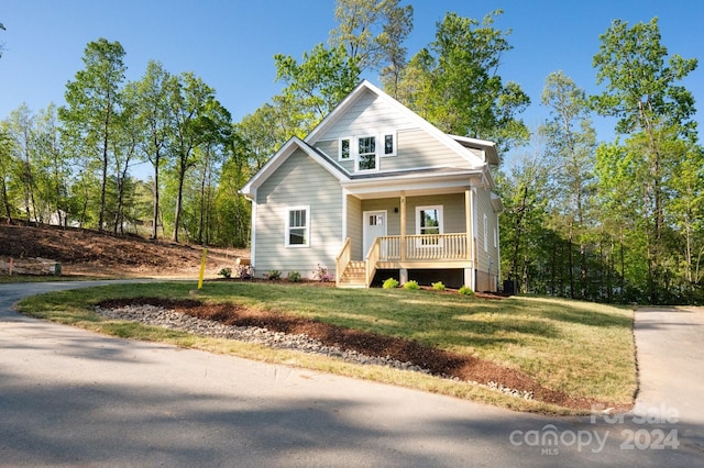 view of front of house with a front yard and covered porch