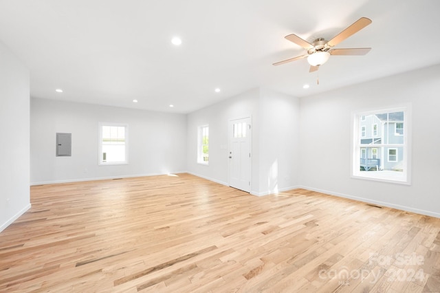 empty room with light hardwood / wood-style flooring and ceiling fan